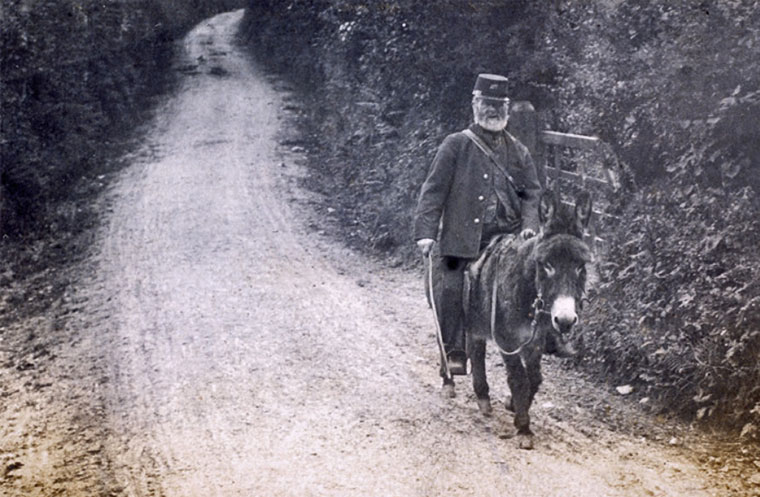 Postman riding a donkey. Possibly in the Caerleon area. Photo by William Henry Thomas, around 1910.