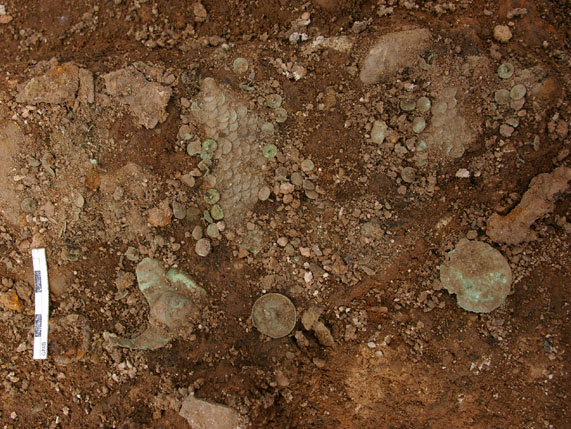 Some of the armour finds at Caerleon 2010. (Image courtesy of excavation team.) Notice the small relief head on the larger piece in the lower left of the picture. The curators and conservators from the National Museum of Wales assisted in block-lifting the whole area. The objects will now be 'excavated' in the museum's labs - a painstakingly slow process - but the results will make it all worth while.