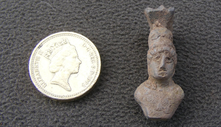 Miniature bust with a crested helmet - probably Minerva. Possibly decoration from a lamp. Found during the 2010 Caerleon excavations.