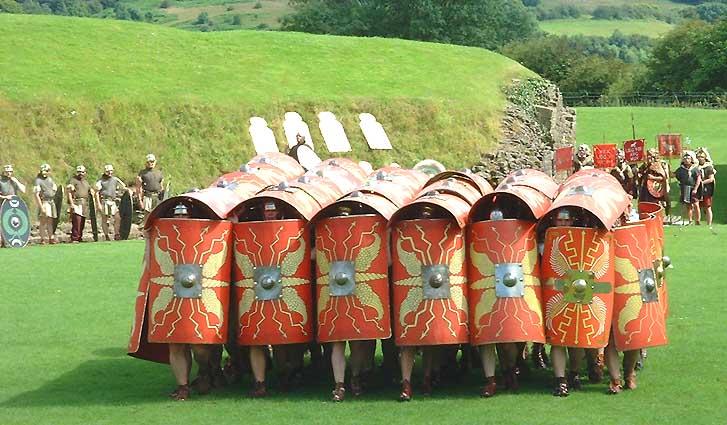 Roman Legionary soldiers demonstrating the testudo or tortoise formation in the Roman Amphitheatre Caerleon